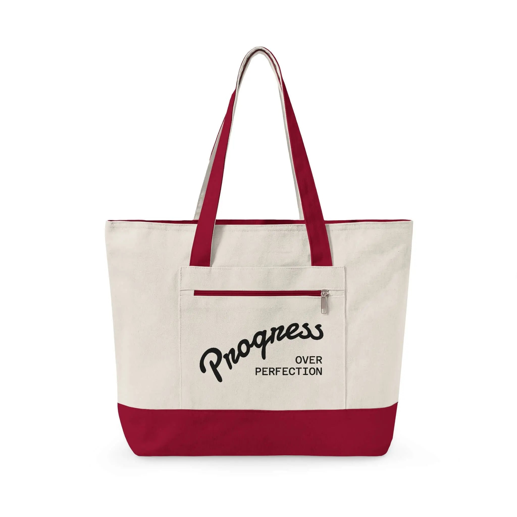 Progress Over Perfection Tote Bag | Minimalist canvas tote bag with black straps and zipper pocket featuring the motivational quote “Progress Over Perfection” in bold black typography on a neutral cream background.