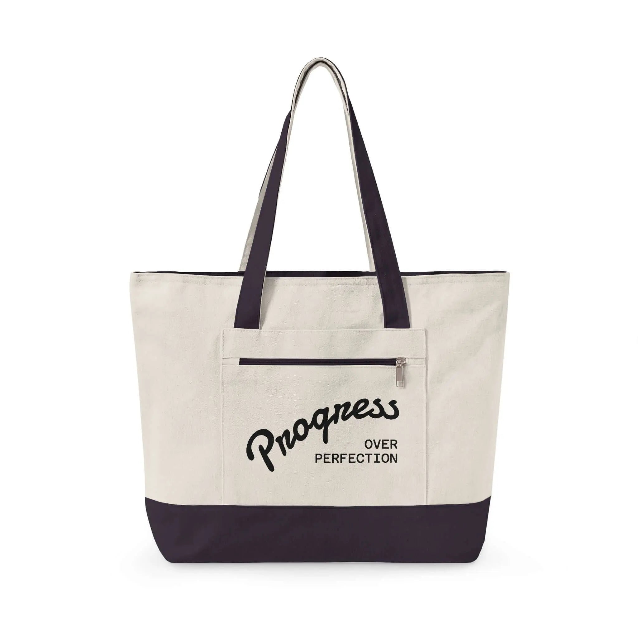 Progress Over Perfection Tote Bag | Minimalist canvas tote bag with black straps and zipper pocket featuring the motivational quote “Progress Over Perfection” in bold black typography on a neutral cream background.